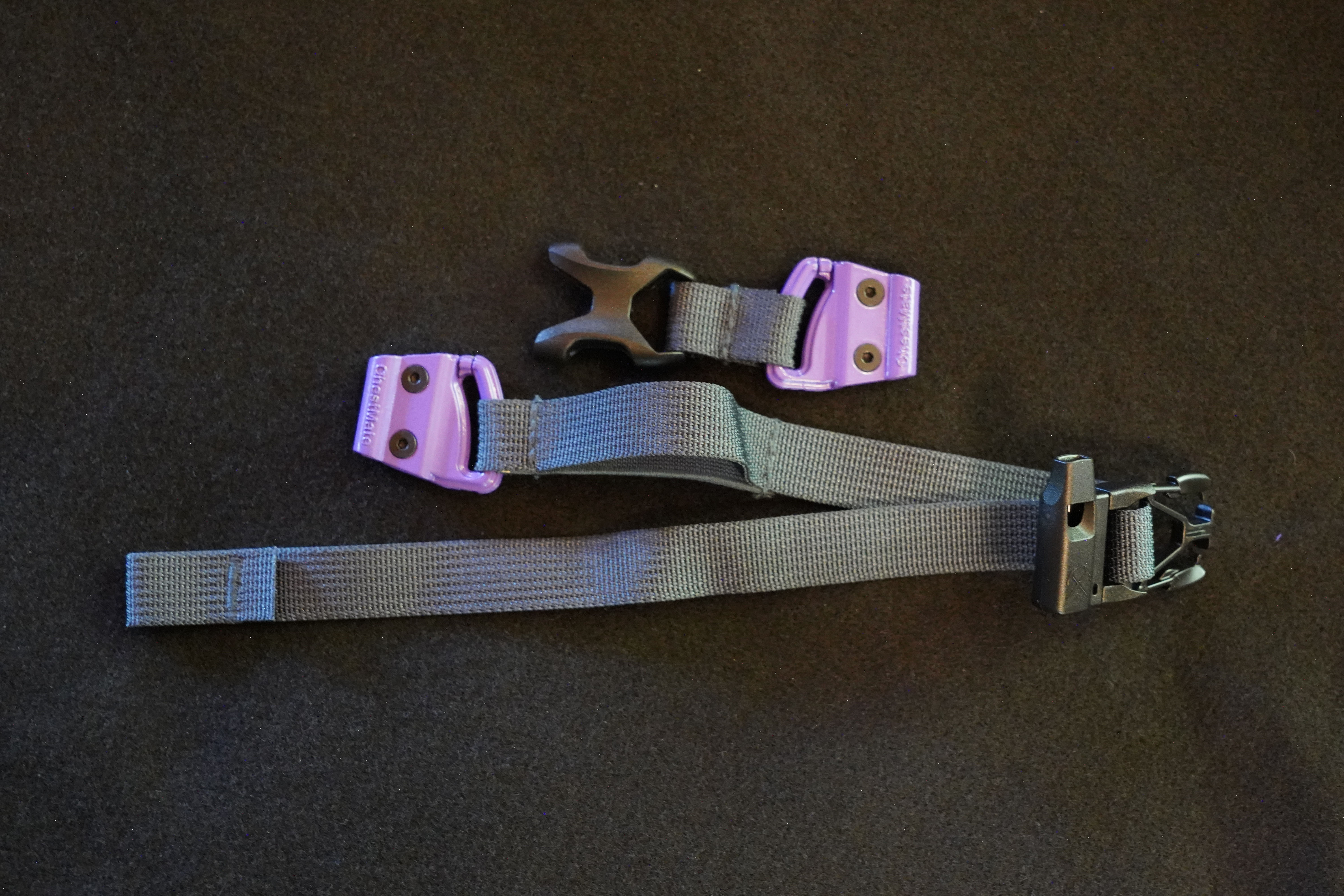 Machined aluminum ChestMate sliders threaded onto a pack's sternum-strap webbing